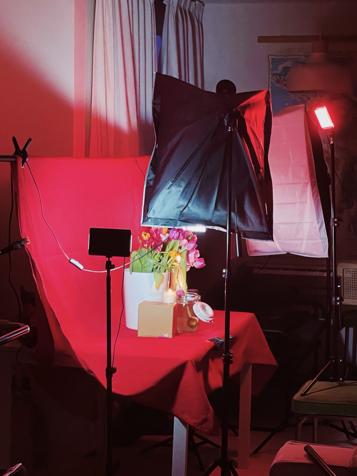 Photo studio set with red backdrop and lights