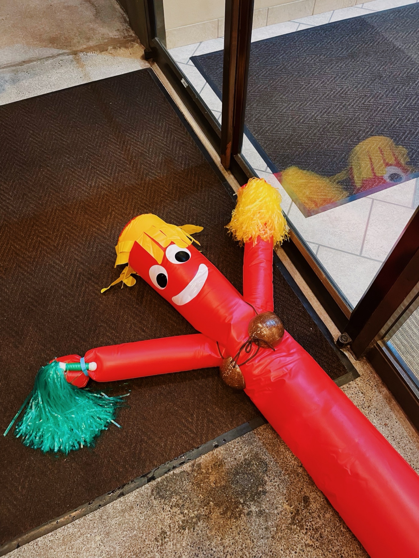Inflatable tube man lying by a door